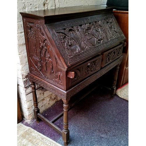 43 - A late 19th / early 20th century carved padouk wood scholar's bureau on stand, profusely carved with... 