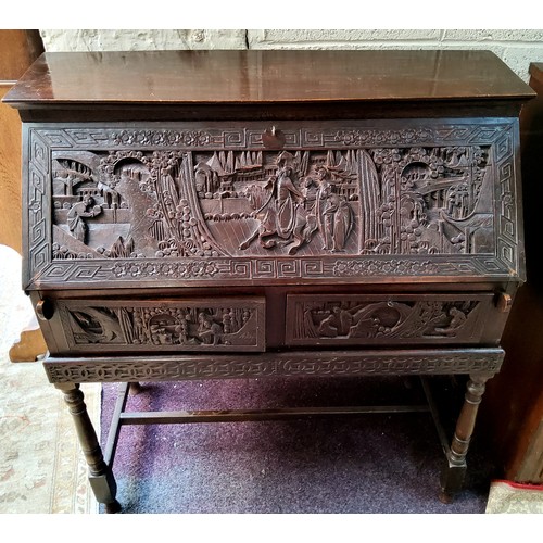 43 - A late 19th / early 20th century carved padouk wood scholar's bureau on stand, profusely carved with... 