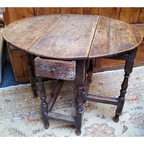 55 - An 18th century English oak drop leaf gateleg tavern table, drawer to frieze, turned supports c.1750... 