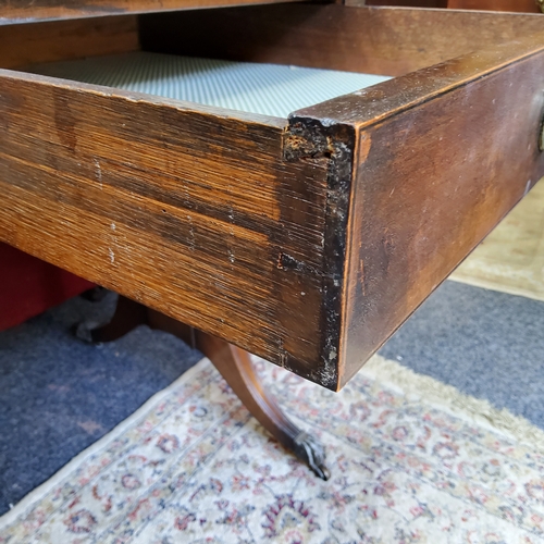 86 - A Regency style sofa table, two short drawers to frieze, brass lion paw feet