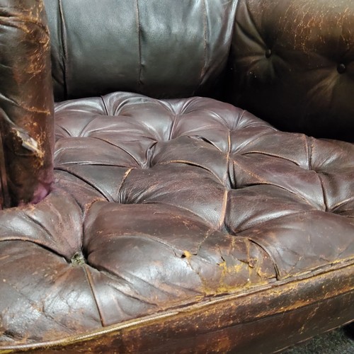 99 - A Victorian leather arm chair, button back and seat, scroll arms, turned mahongay legs, c.1860