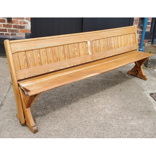 163 - A Victorian pitch pine church pew, slatted back, 240cm long, c,1860