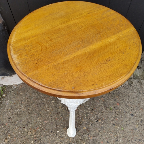 165 - A Victorian cast iron pub table, bold mask capped trio with pierced circular under tier, later golde... 