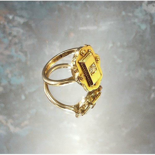 244 - An unusual Victorian 18ct gold ring the large shaped setting centrally set with round diamond approx... 