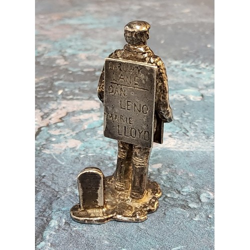 250 - A novelty silver place card/menu holder,   cast as a man with a sandwich board, advertisin... 