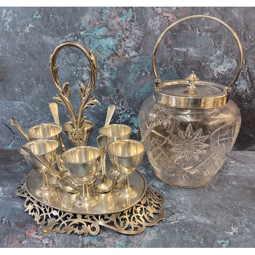 270 - A 19th century plated ware egg stand, six cups and spoons, posted loop handle, pierced scroll base, ... 