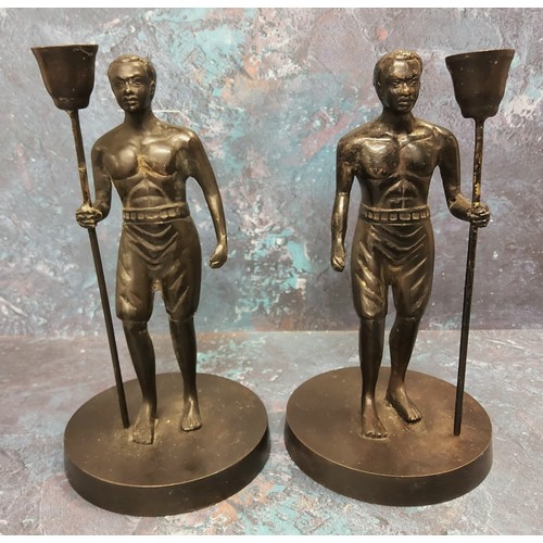 276 - A pair of bronze figural candlesticks, cast as Nubians, holding staffs, 19th century