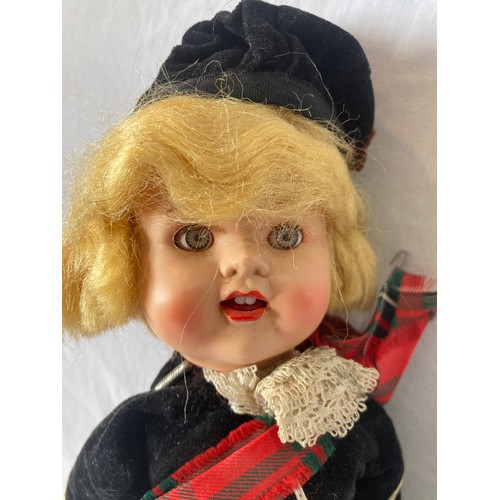 375 - A Roddy hard plastic walking doll, in Scottish dress, 30cm high, c.1950;  a Rosebud costume dol... 