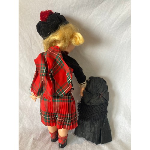 375 - A Roddy hard plastic walking doll, in Scottish dress, 30cm high, c.1950;  a Rosebud costume dol... 