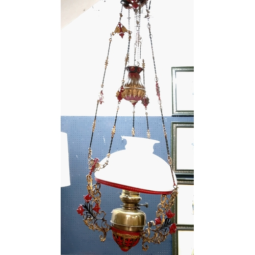 392 - A 19th century ceiling oil lamp, later painted in red and gilt, opaque domed shade, weighted rise an... 