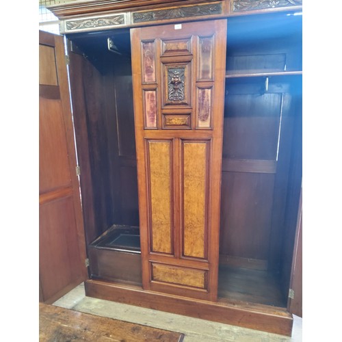 153A - A Victorian burr walnut and mahogany double wardrobe, the oversailing cornice above central blind do... 