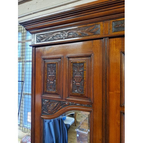 153A - A Victorian burr walnut and mahogany double wardrobe, the oversailing cornice above central blind do... 