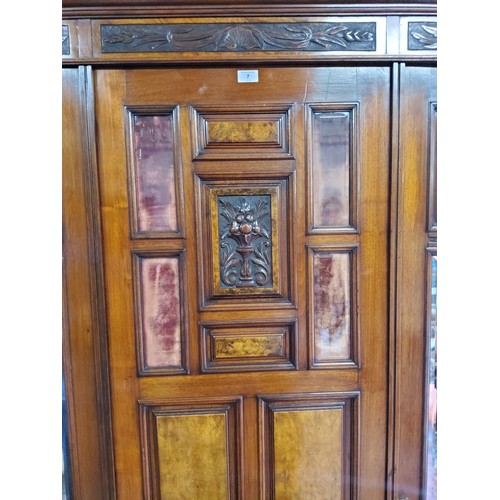 153A - A Victorian burr walnut and mahogany double wardrobe, the oversailing cornice above central blind do... 