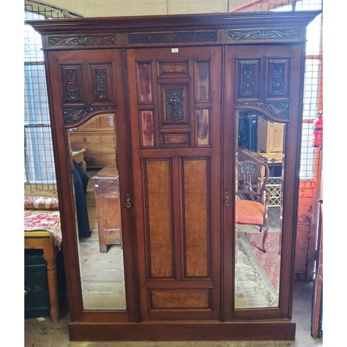 153A - A Victorian burr walnut and mahogany double wardrobe, the oversailing cornice above central blind do... 