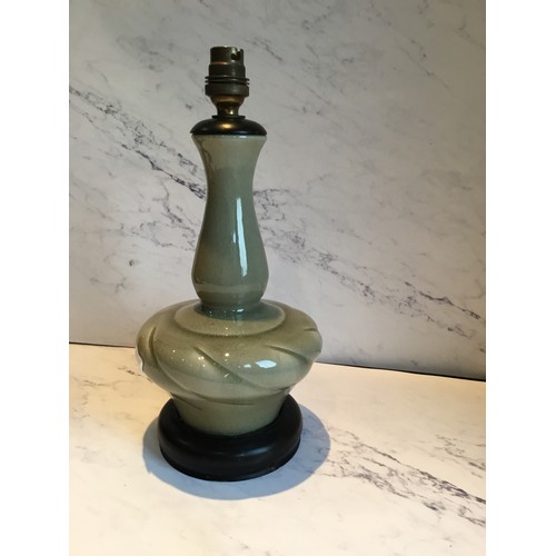 49 - A Korean celedon side light, ebonised base, 34cm high