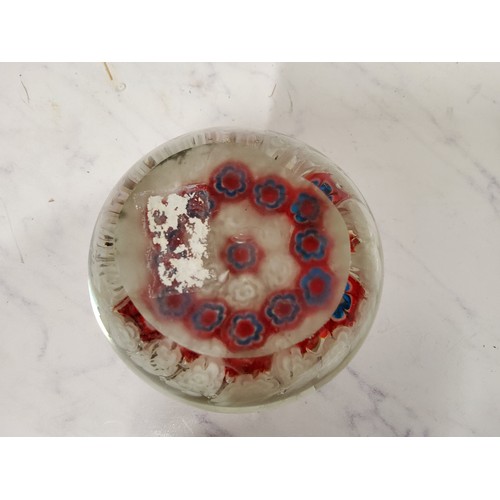 54 - An English domed glass millieflori paperweight, alternating floral stems in red and white, 8cm diam;... 