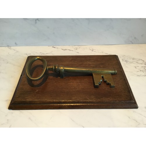 55 - A late 19th century novelty desk letter clip, in the form of key,  oak rectangular base, 25cm l... 