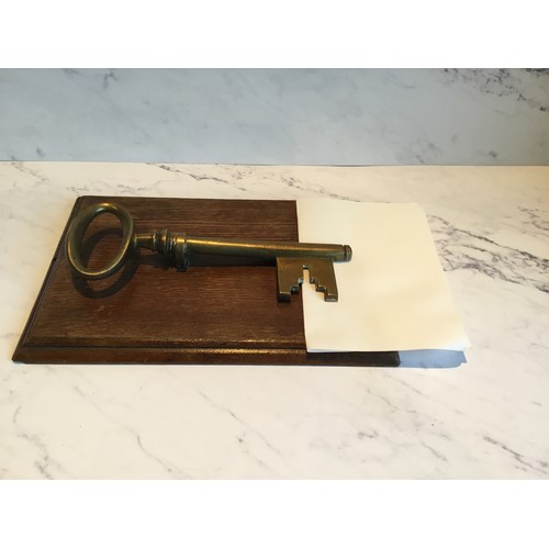 55 - A late 19th century novelty desk letter clip, in the form of key,  oak rectangular base, 25cm l... 