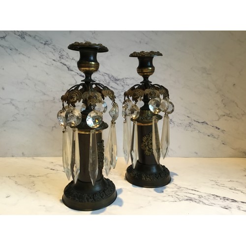 56 - A pair of Regency bronze candle lustres, cast with stylised leaves, clear glass prismatic droplets, ... 