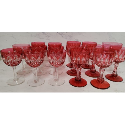 66 - A set of seven ruby glass overlaid wine glasses, waisted columns, spreading circular bases, 12.75cm ... 