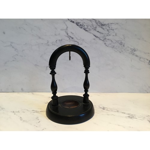 89 - A Victorian ebonised pocket watch stand, the circular base with label From California House Haberdas... 