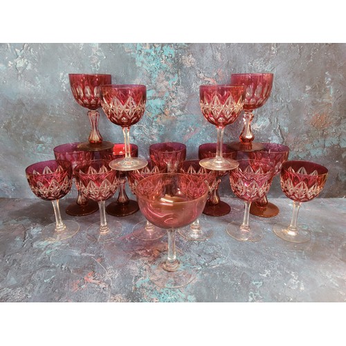 66 - A set of seven ruby glass overlaid wine glasses, waisted columns, spreading circular bases, 12.75cm ... 