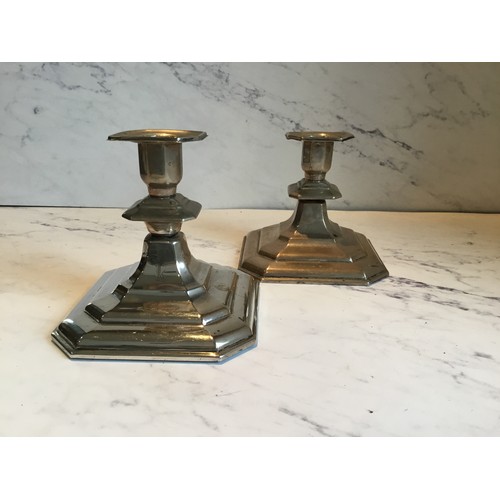 240 - A pair of Continental silver coloured metal  candlesticks, canted sqare sconces, spreading base... 