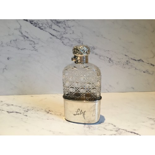 299 - A silver and hobnail cut glass hip flask, detachable cup, hinged domed cover, embossed with scrolls,... 