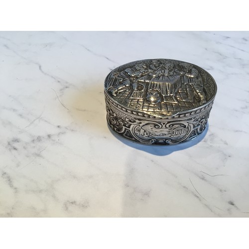 304 - A 19th century Dutch silver oval box, embossed with tavern scene, the sides with scrolls, 2.75cn hig... 