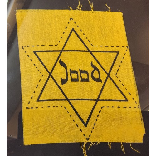 121 - A WWII Dutch Jewish patch in the form of the Star of David with the word 'Jood' in the centre, unuse... 