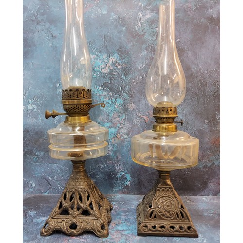 134 - A Victorian cast iron oil lamp, clear glass resevoir, pierced cast iron base, 51cm high, c.1890;  an... 