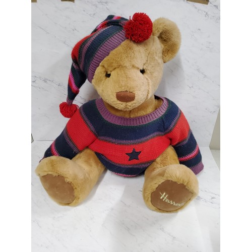 438 - A large Harrods jointed bear, woollen hat and jumper, 75cm high