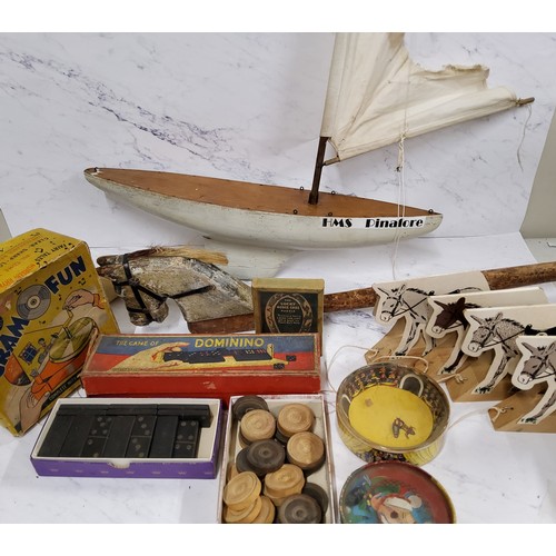 442 - A Triangtois wooden hobby horse; HMS Pinafore pond yacht; various domino sets; a Magico Rub it game;... 