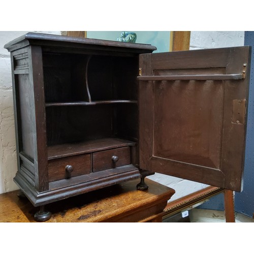 487 - An early 20th century oak table top, smokers cabinet, carved ;lozenge panelled door, fitted interior... 