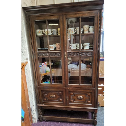 646 - A 20th century oak display cabinet, carved glazed doors, barley twist legs, 183cm high, 106cm wide, ... 