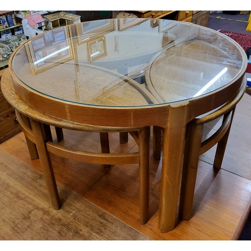 626 - A mid 20th century design Nathan teak circular glass top coffee table,  enclosing three 'oval' side ... 