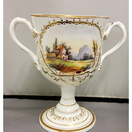 105 - A Victorian Coalport type  two handled loving cup, painted with landscape cartouches within a g... 