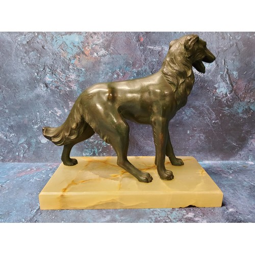 134 - Art Deco, 1930, a green patinated spelter Borzoi, rectangular onyx base, 18cm high, 20cm wide