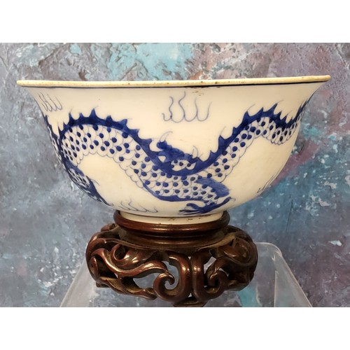 179 - A 19th century Chinese bowl, the exterior in cobalt blue with the dragon chasing the flaming pearl, ... 