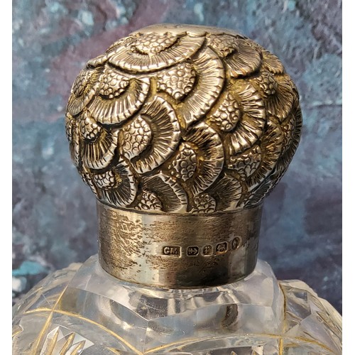 190 - A large Victorian clear cut glass and silver scent bottle, the screw-off cover embossed with stylise... 