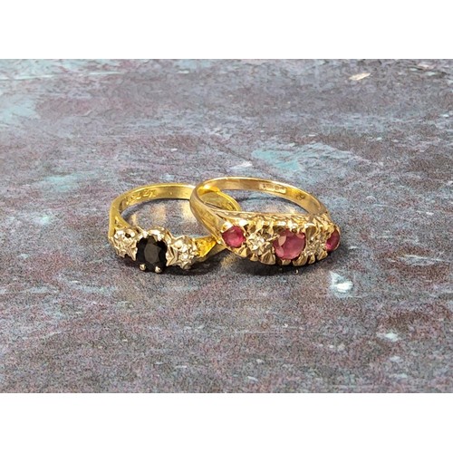 336 - A 9ct gold five stone ring set with a central round ruby, flanked by two round diamonds and further ... 