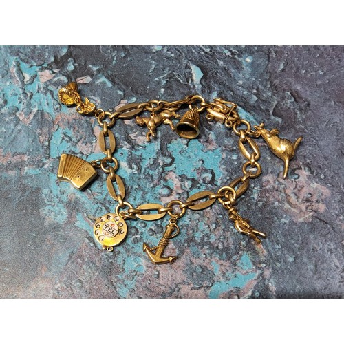 348 - A 9ct gold fancy link bracelet with eight charms including a telephone dial, a Hohner Accordion, Kan... 