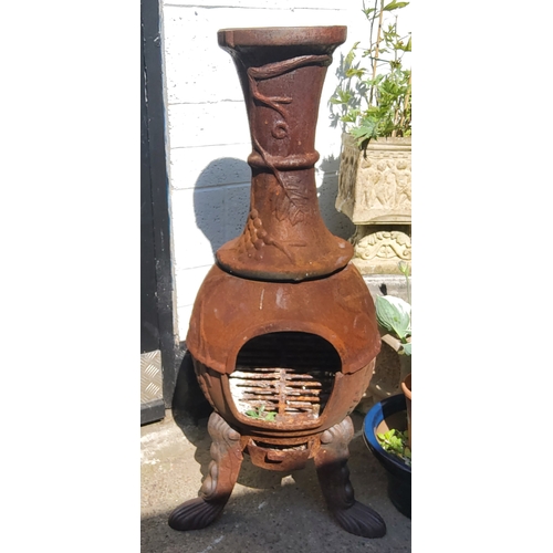 414 - A large cast metal garden chiminea