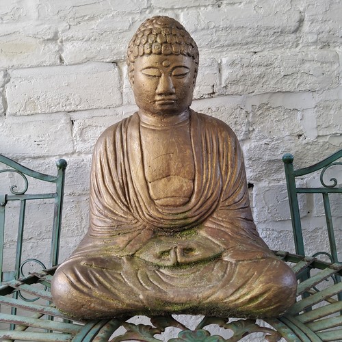 420 - A reconstituted stone Buddha garden statue