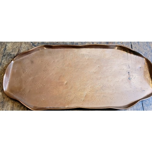 116 - An Arts and Crafts Newlyn type copper shaped oval tray, engraved with stylised fish and fronds, 57cm... 