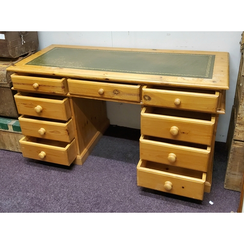 636 - A 20th century pine pedestal desk, tooled green leather inlaid writing surface, three drawers to fri... 