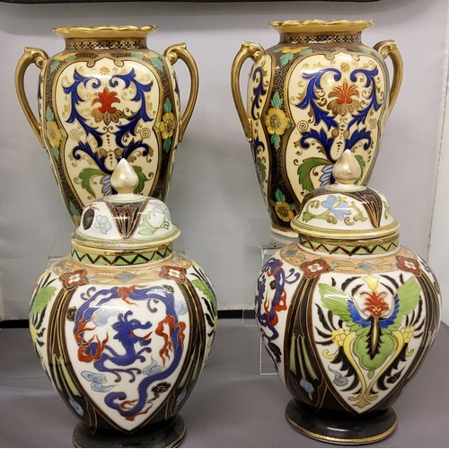 40 - A pair of Noritake ovoid vases, decorated with cartouches, each with scrolling foliage, in blue, red... 