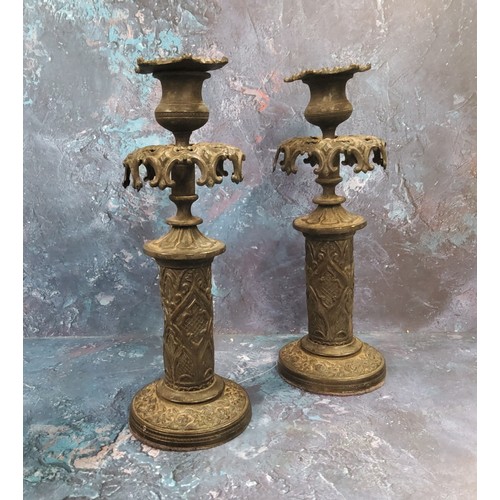 118 - A pair of 19th century bronze Gothic Revival candlesticks, pierced everted foliate sconces, the colu... 