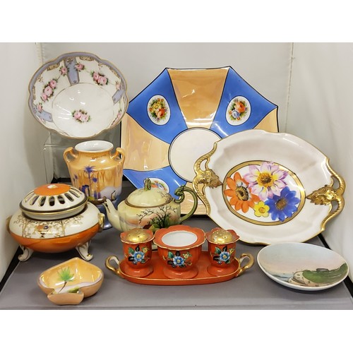 217 - Noritake - a three piece cruet set, on stand, decorated with flowers on an orange ground, green mark... 