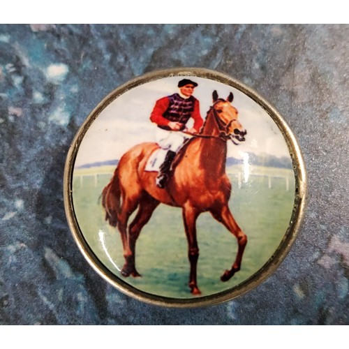 294 - A 19th century circular snuff box, the cover enamelled with horse and jockey, marked 925